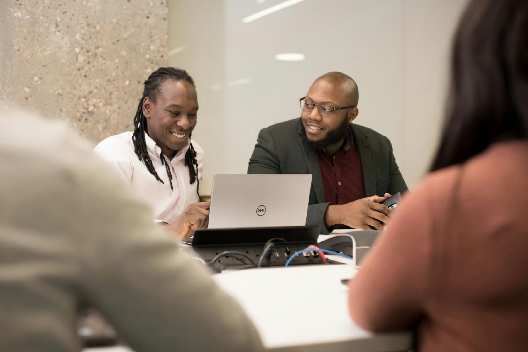 Hiring manager reviewing a shortlisted developer's work on a laptop