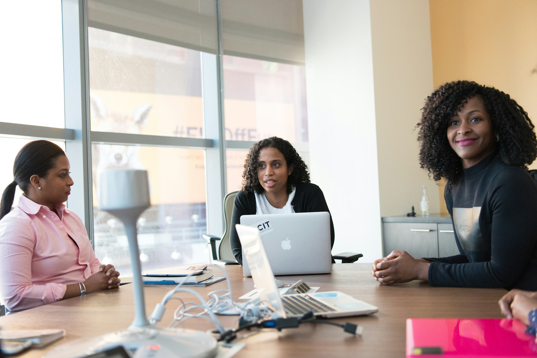 Technology team working together around a table in a bright office