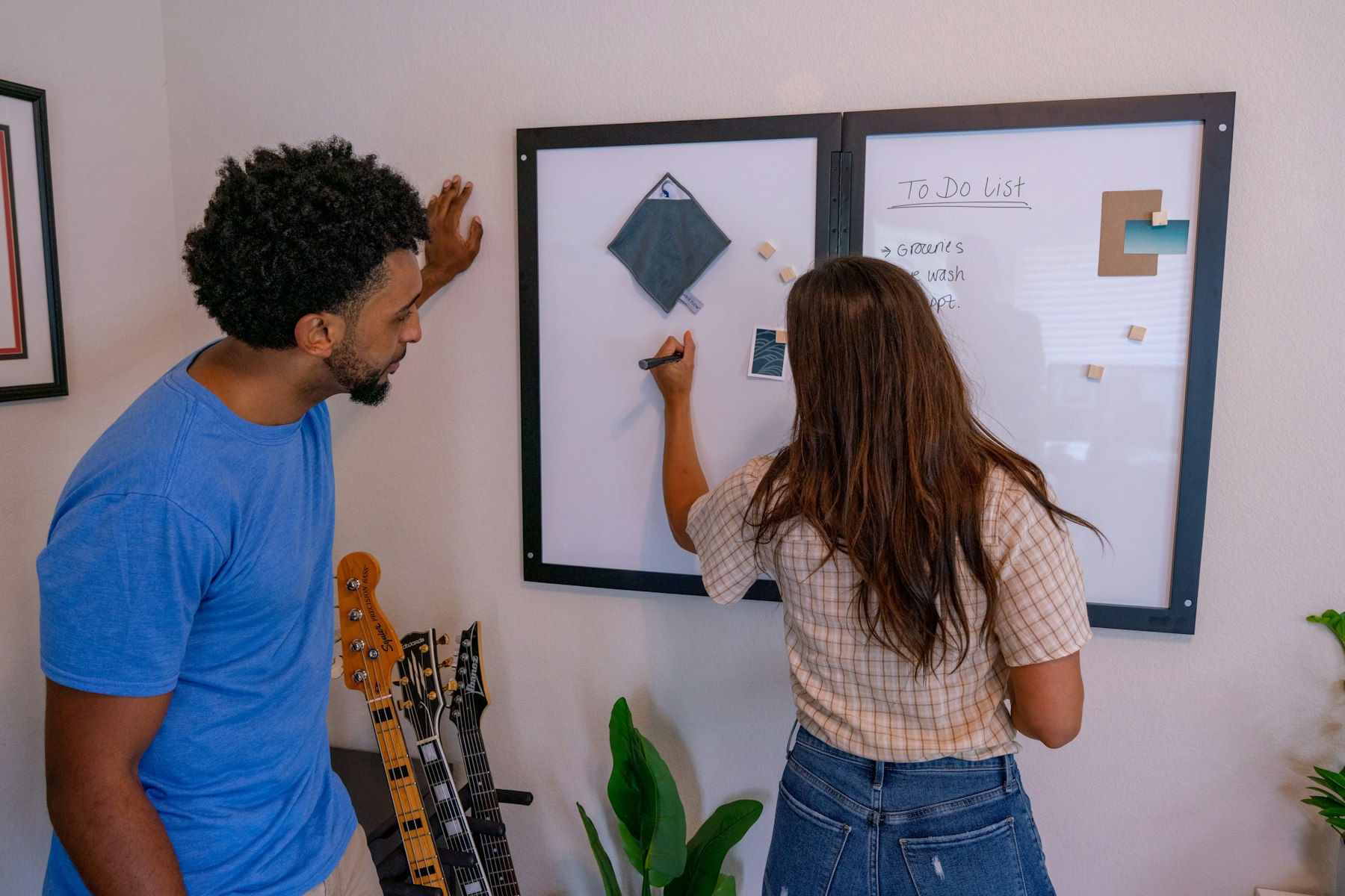 Two colleagues discussing a technology decision at a whiteboard